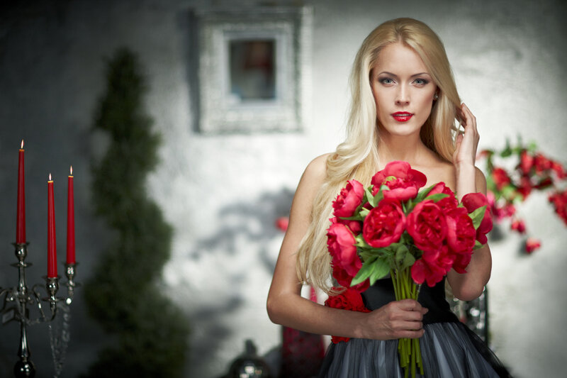 Woman Holding Red Flowers — Dramatic, Photograph
