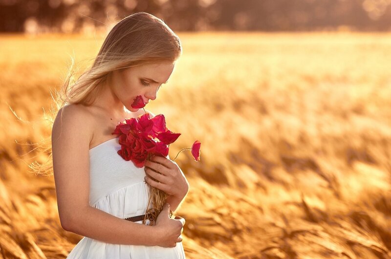 Woman Holding Red Flowers — Serene, Sunset