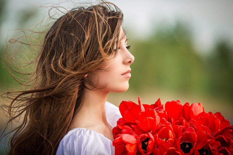 Woman Holding Red Flowers — Serene