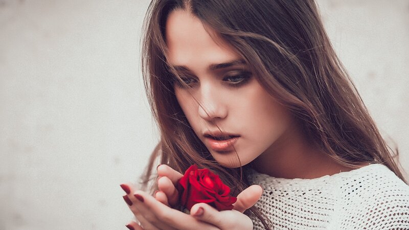 woman holding red rose