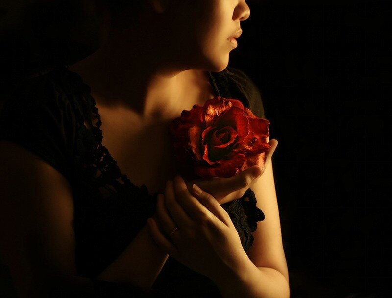 woman holding red rose