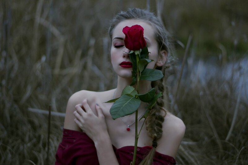 Woman Holding Red Rose — Dramatic, Sunset, Photograph