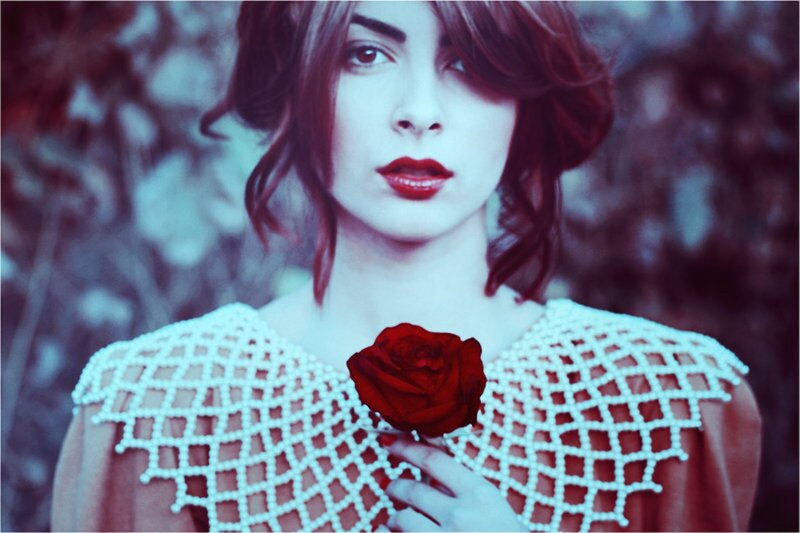 Woman Holding Red Rose — White, Dramatic