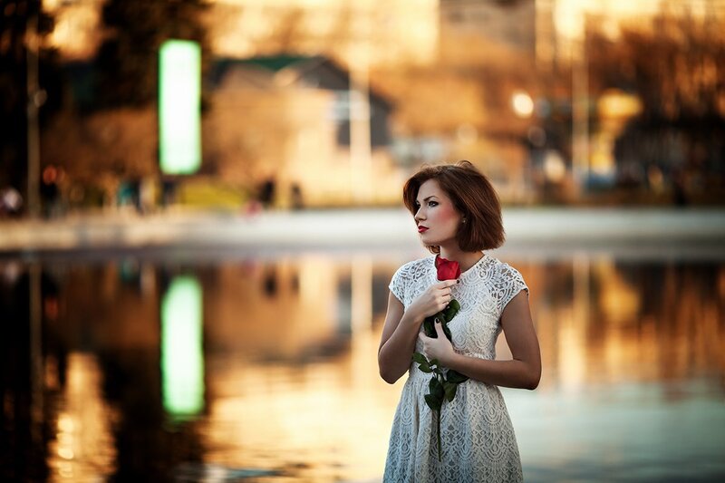 Woman Holding Red Rose — White, Serene, Sunset
