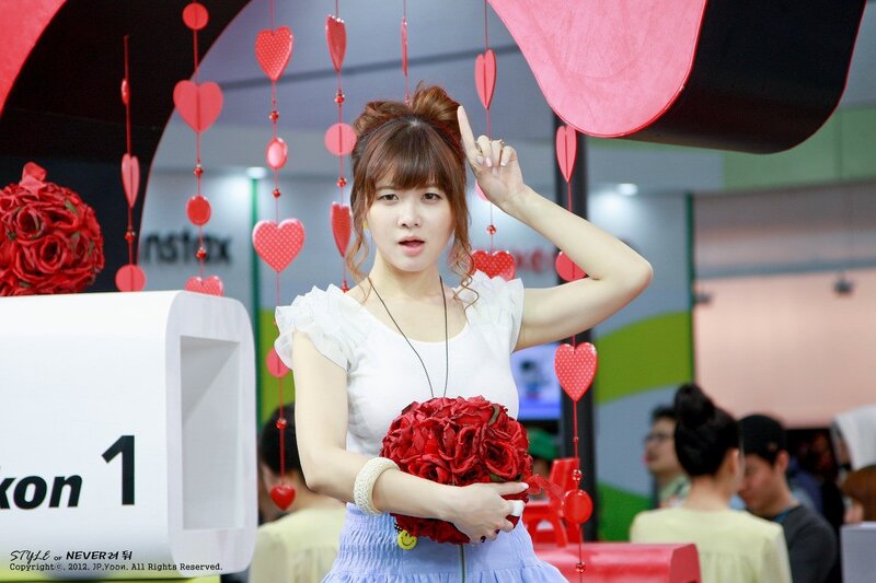 Woman holding red roses at event