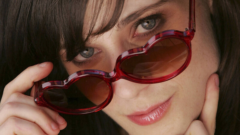woman holding red sunglasses