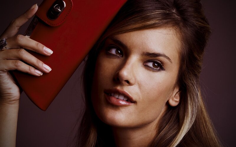 woman holding red wallet