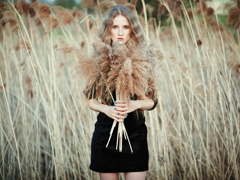 Woman Holding Reeds