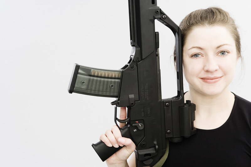 Woman Holding Rifle — Black, Neutral