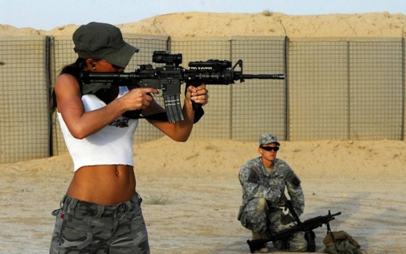 Woman Holding Rifle — Brown, Serious