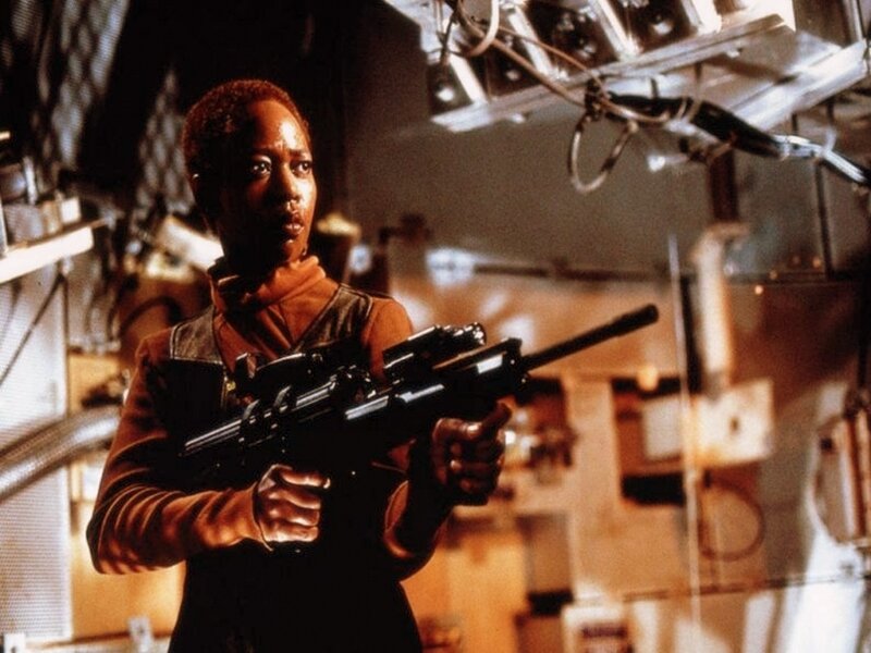 Woman Holding Rifle — Brown, Tense