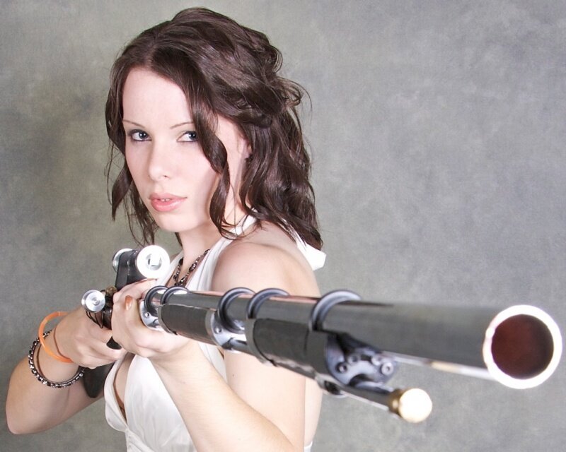 Woman Holding Rifle — Gray, Serious