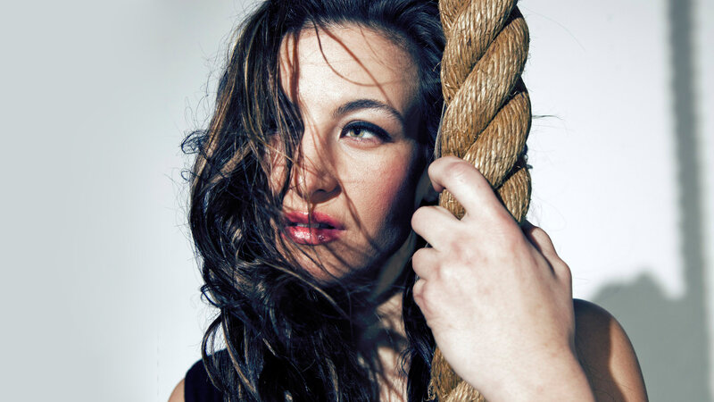 Woman Holding Rope — White, Dramatic