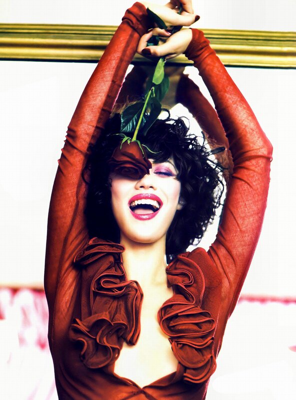 woman holding rose above head