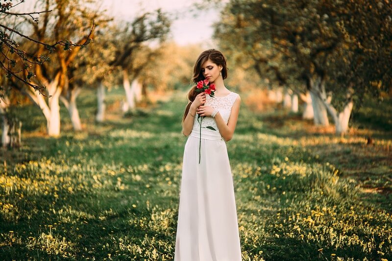 Woman Holding Rose — White, Serene, Sunset