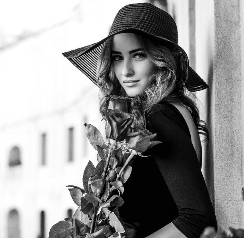 Woman Holding Roses — Black, Dramatic, Photograph, Hat