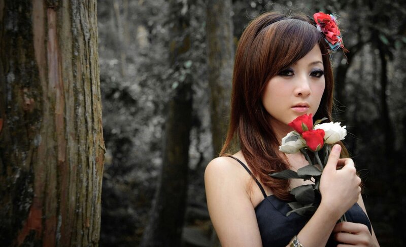 woman holding roses in forest