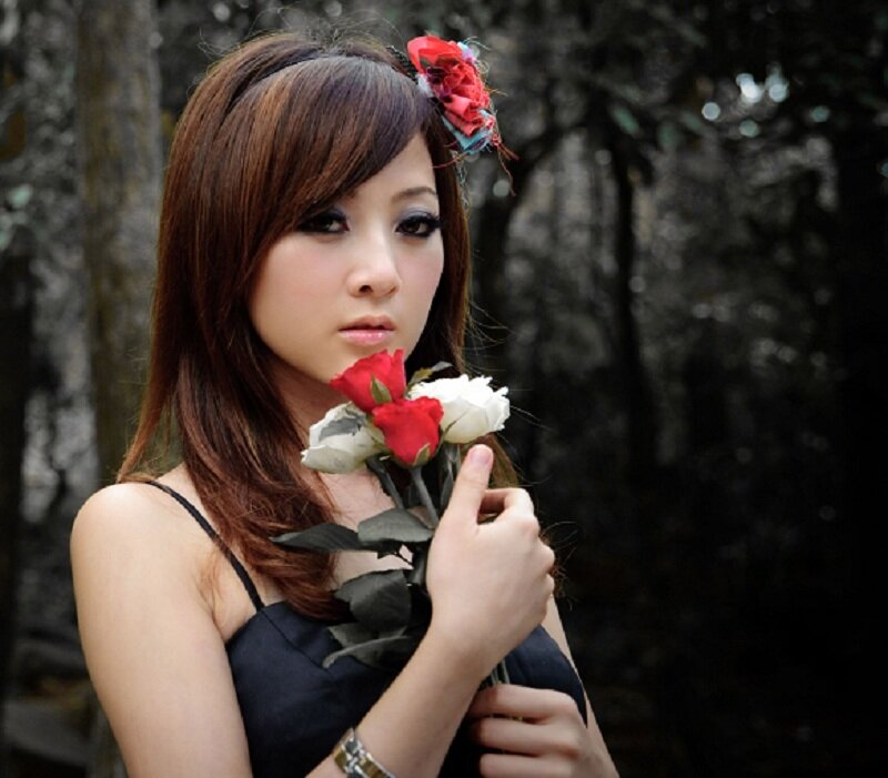woman holding roses in forest