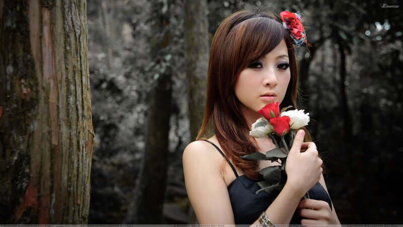 woman holding roses in forest