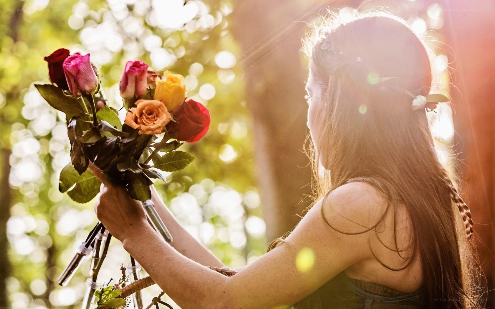 woman holding roses in sunlight