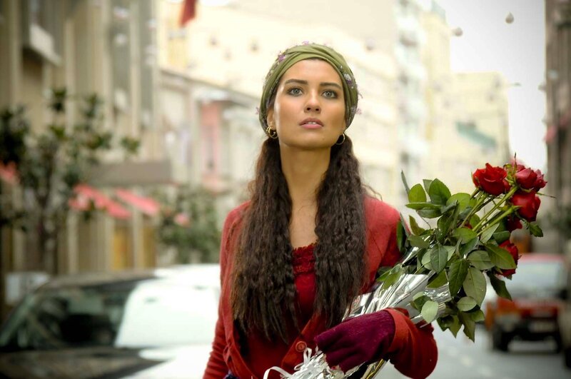 woman holding roses on street