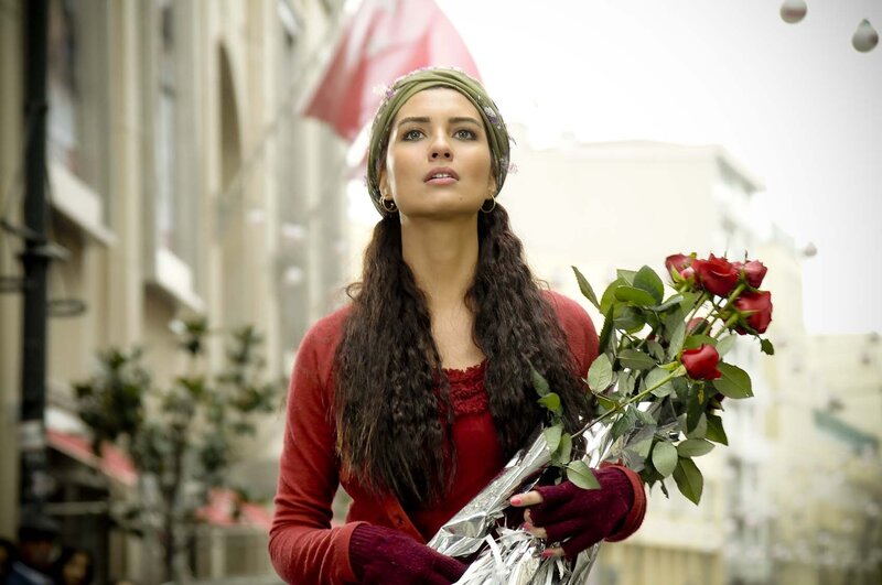Woman holding roses on street