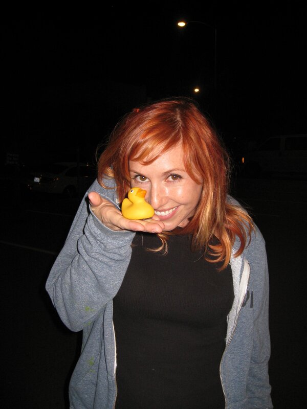 Woman holding rubber duck at night