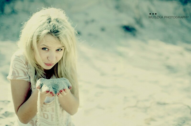 woman holding sand on beach