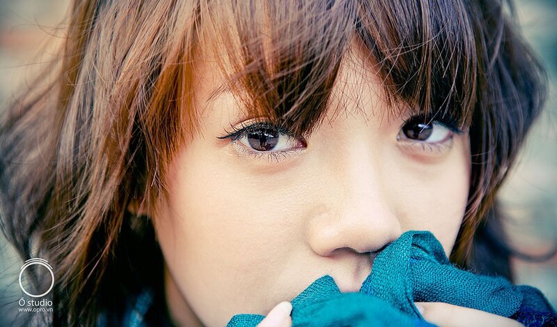 woman holding scarf to face