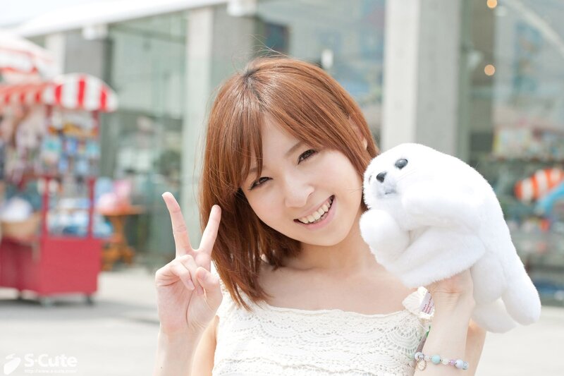 Woman holding seal plush toy