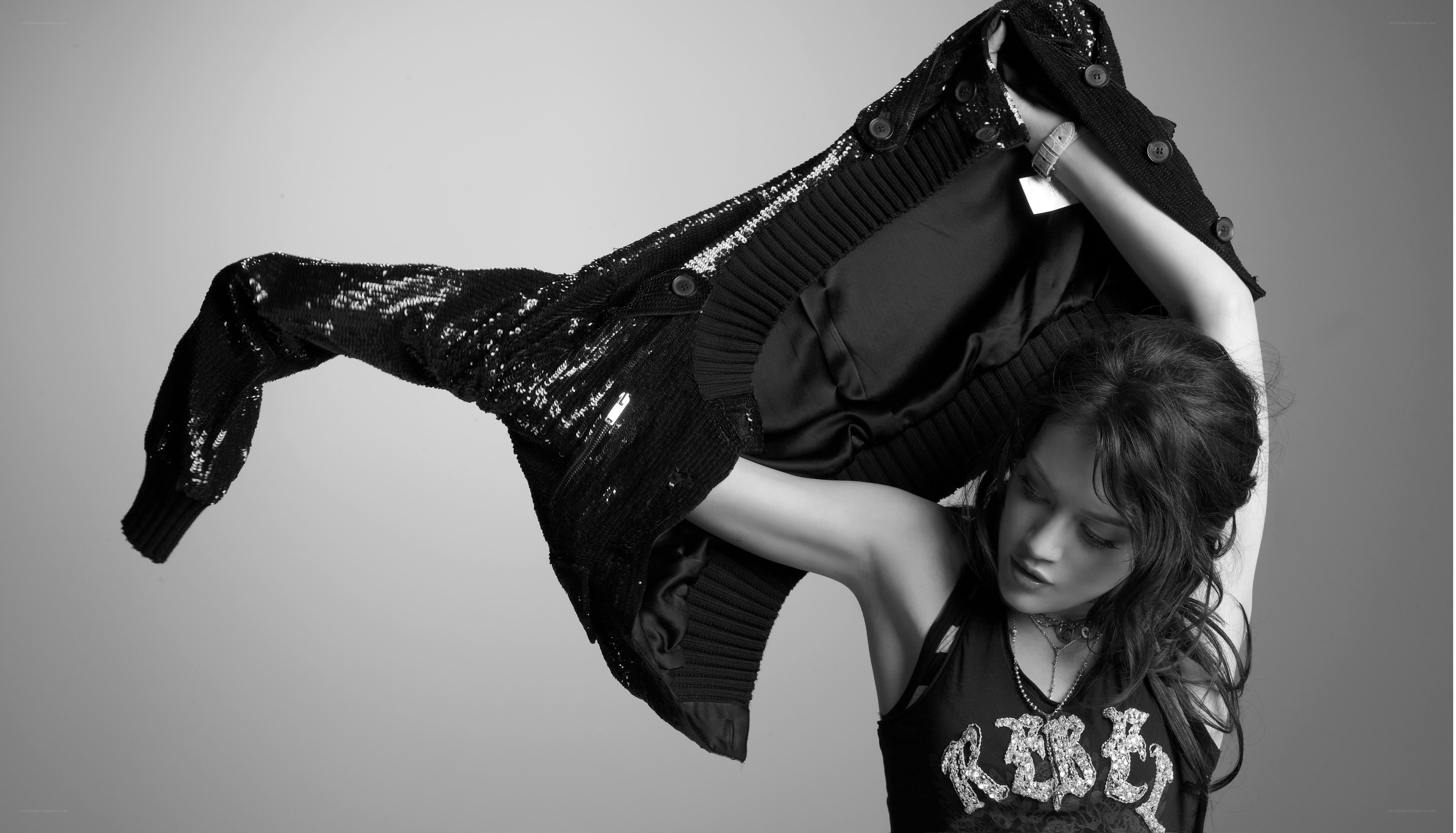 woman holding sequined jacket