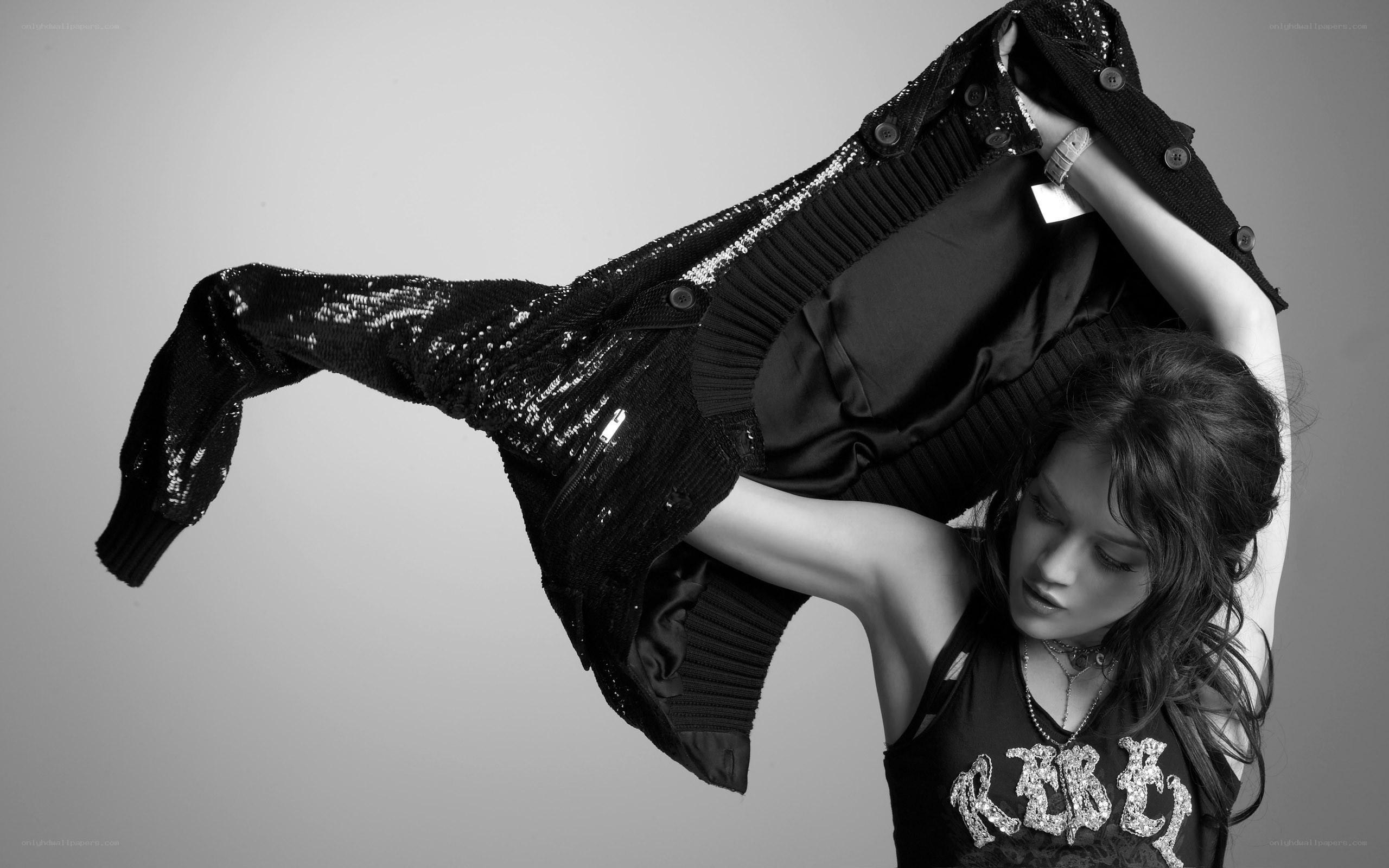 woman holding sequined jacket