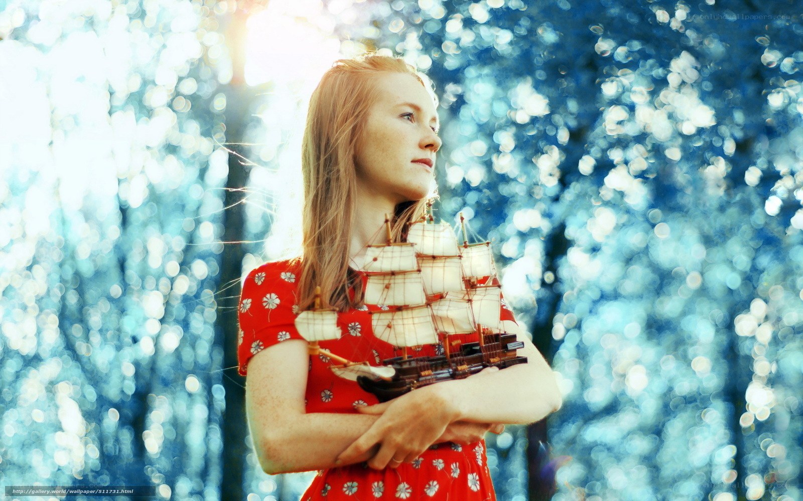 woman holding ship model
