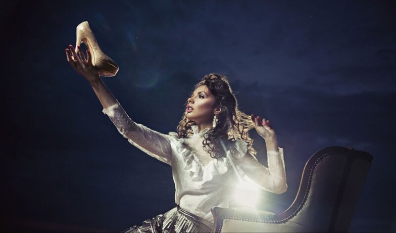Woman Holding Shoe — White, Dramatic