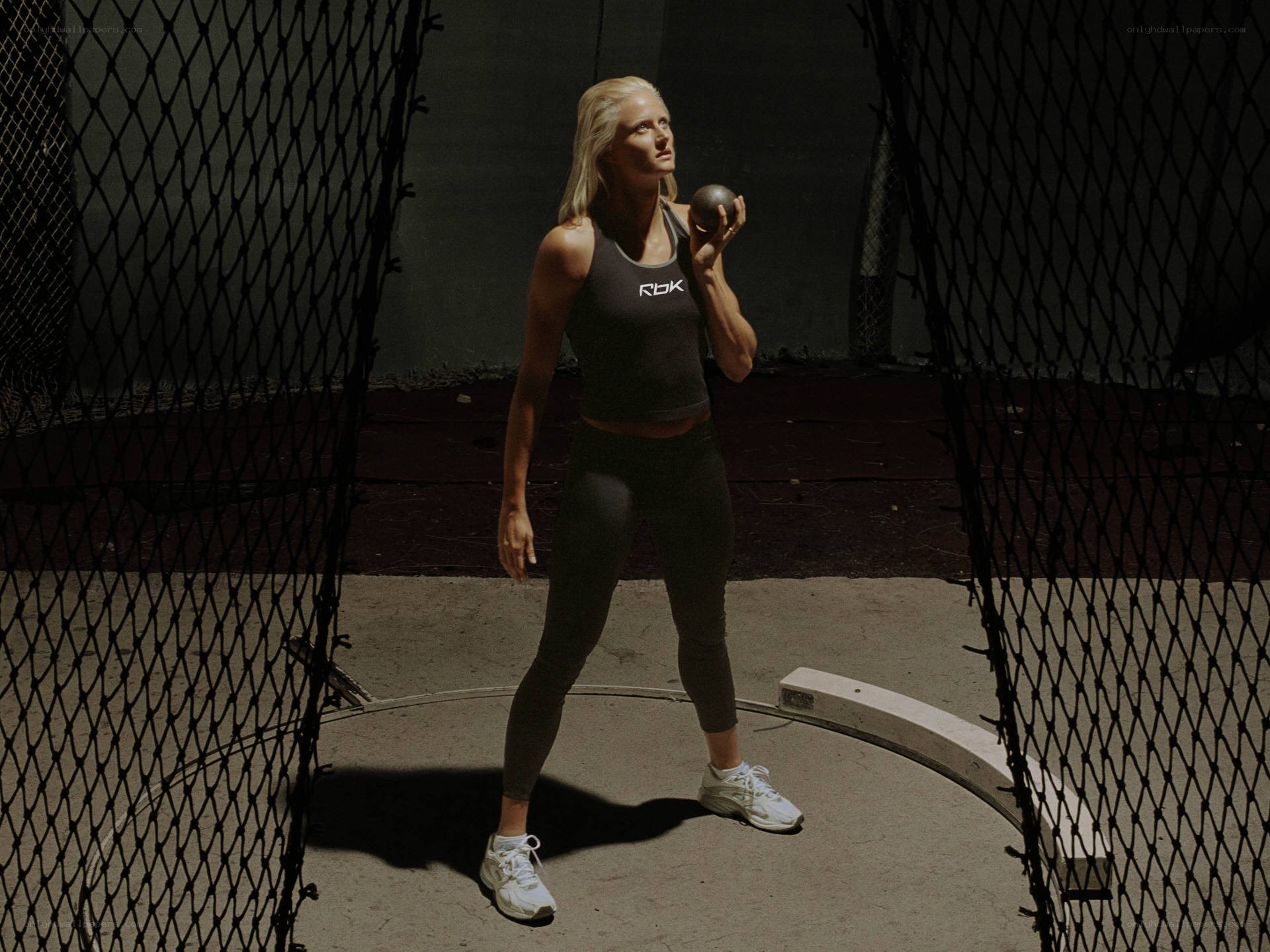 woman holding shot put