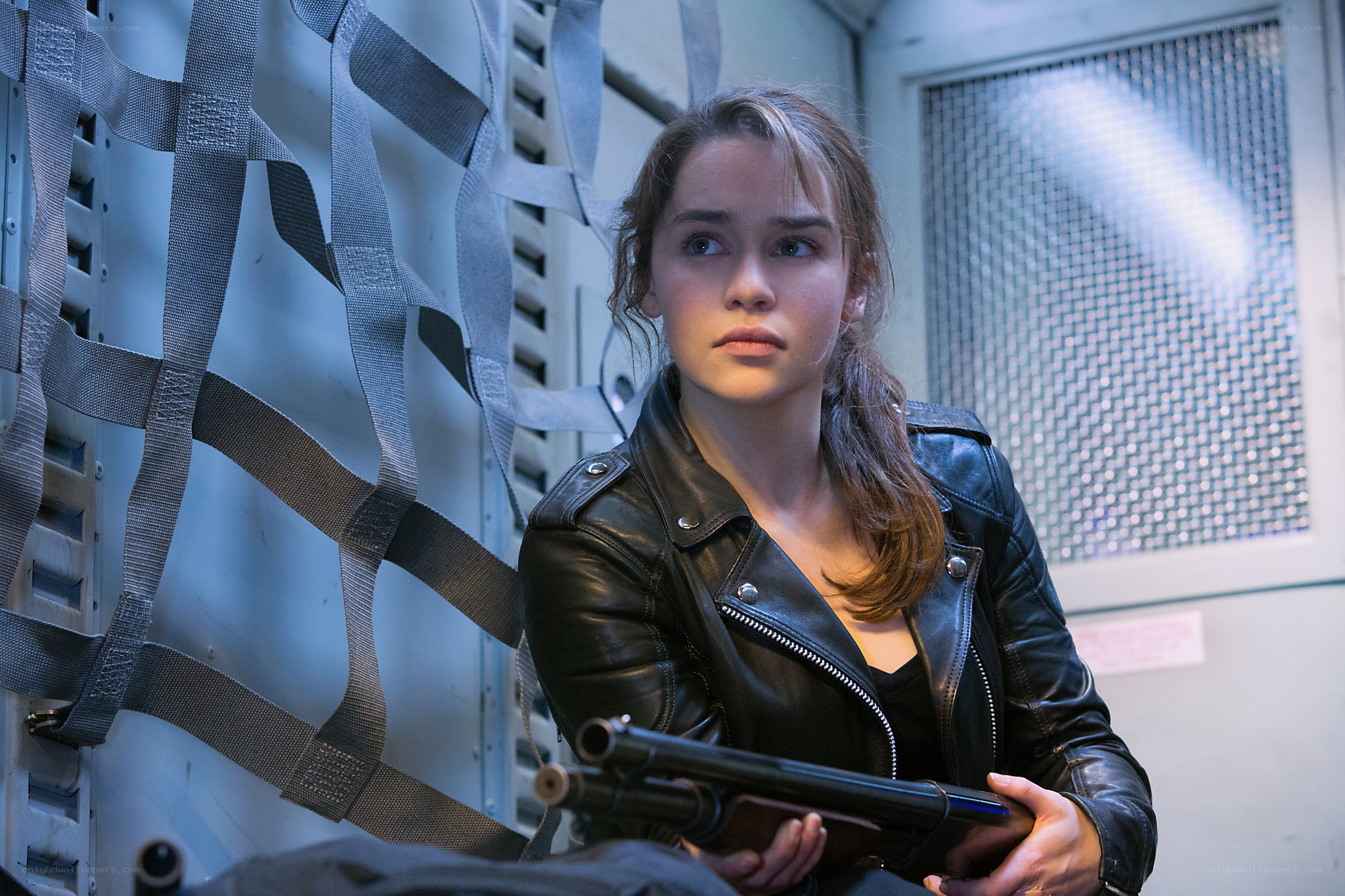 woman holding shotgun in industrial setting