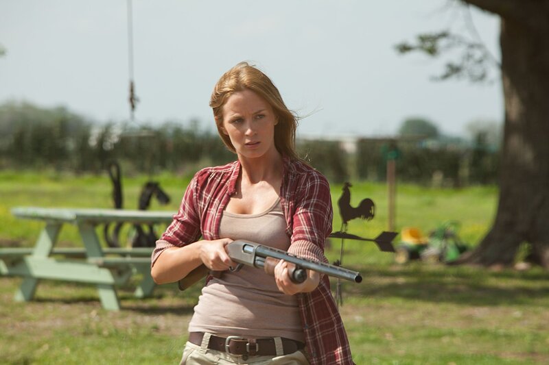 Woman holding shotgun outdoors