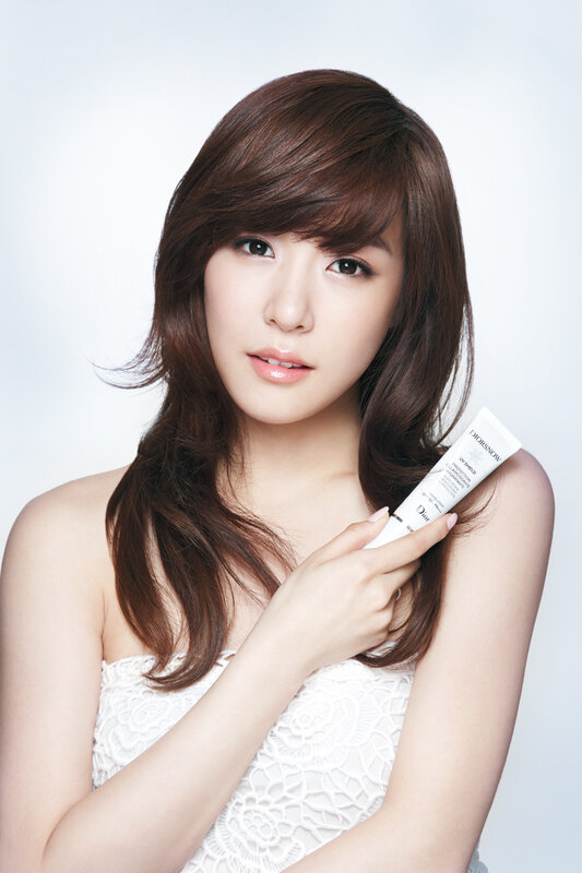woman holding skincare product