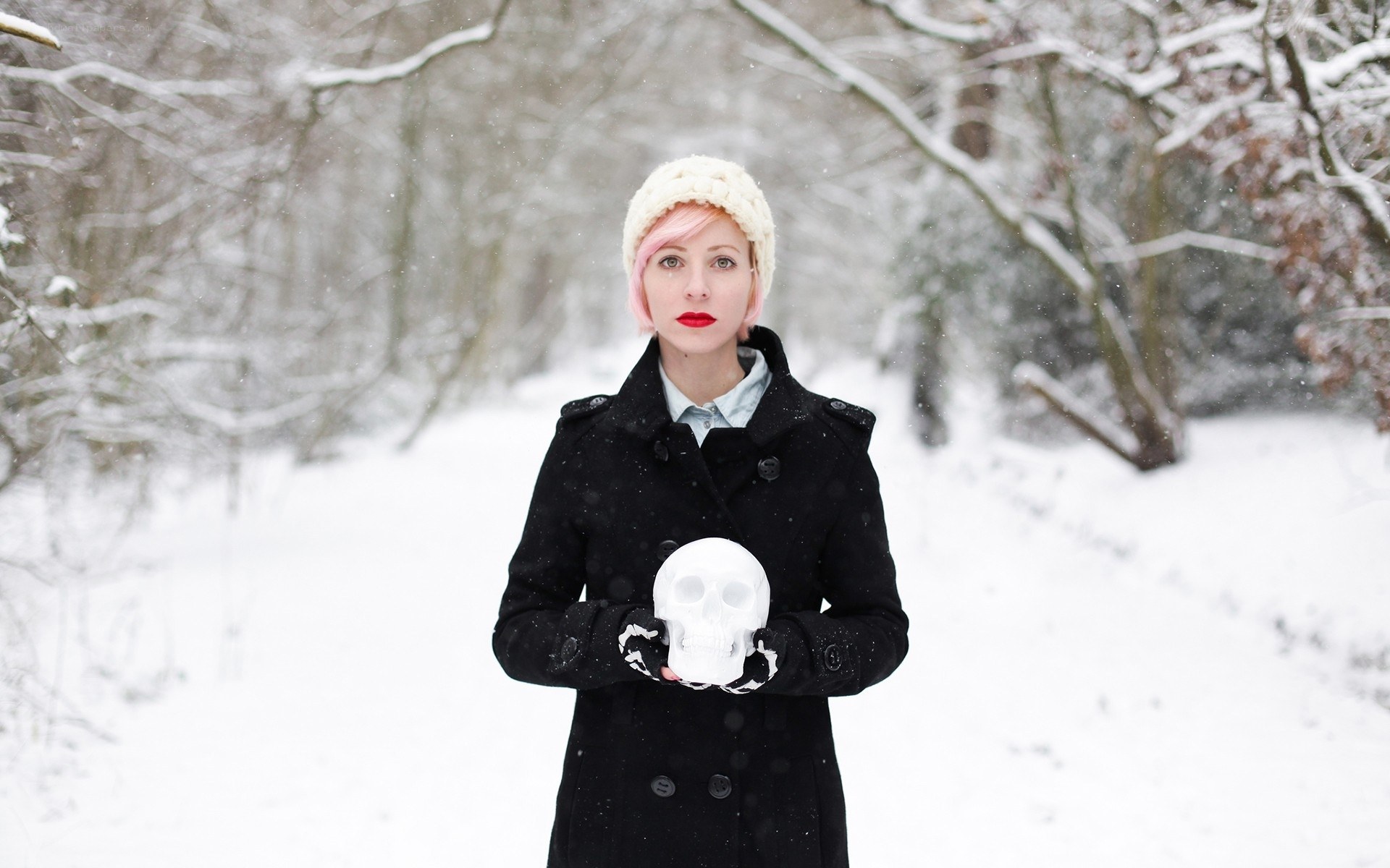 Woman holding skull in snow
