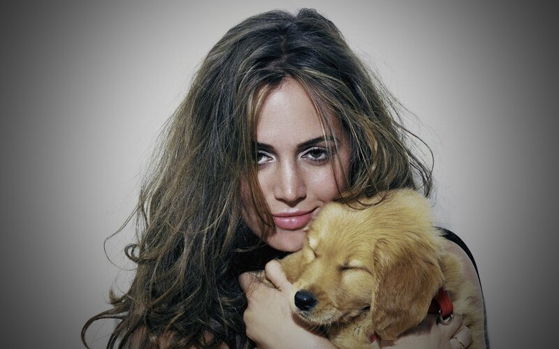 woman holding sleeping puppy
