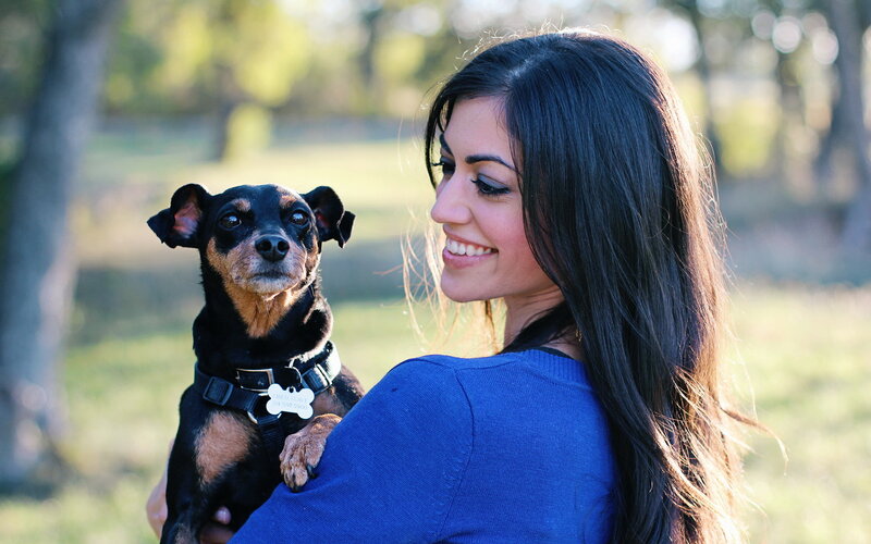 Woman Holding Small Dog — Blue