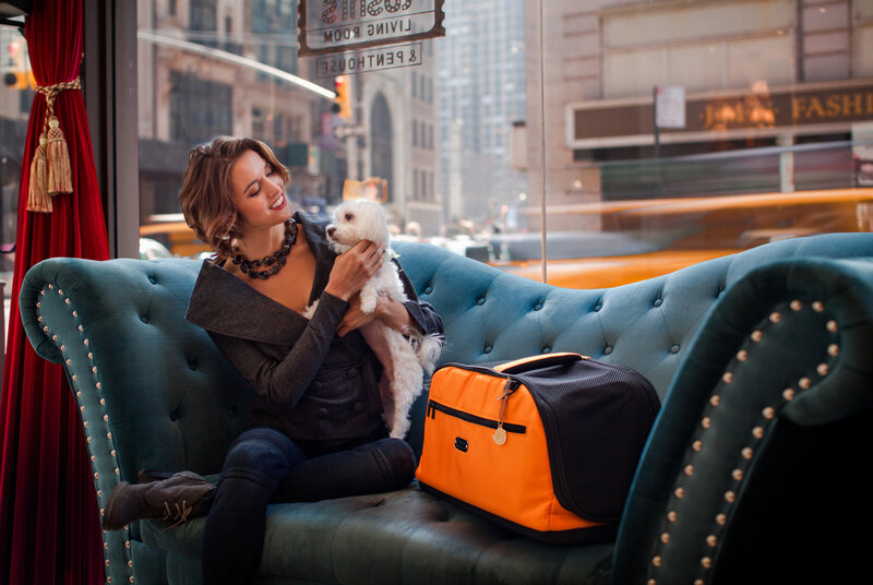 Woman Holding Small Dog — Teal