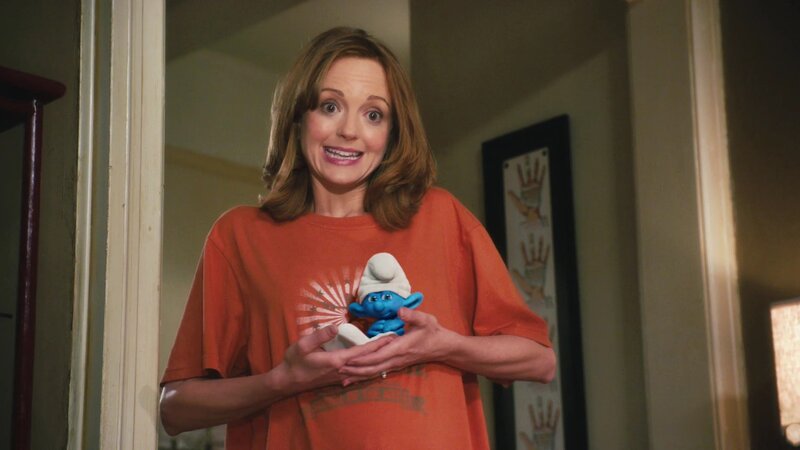woman holding smurf figurine
