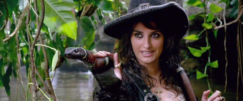 woman holding snake in jungle