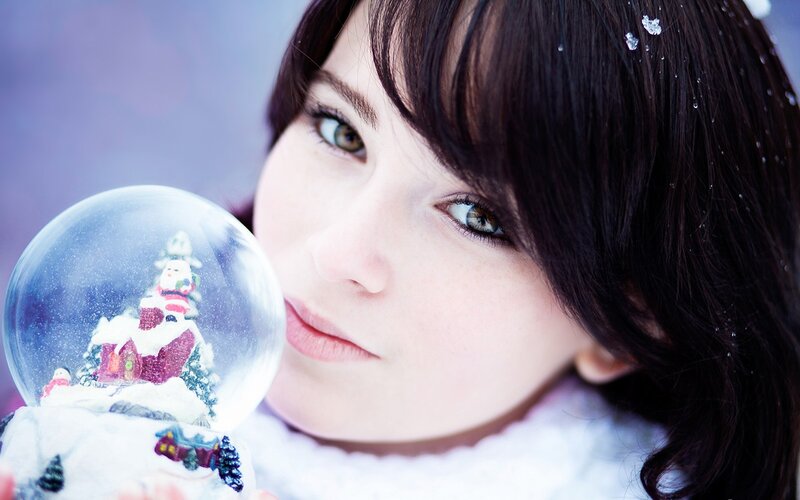 woman holding snow globe