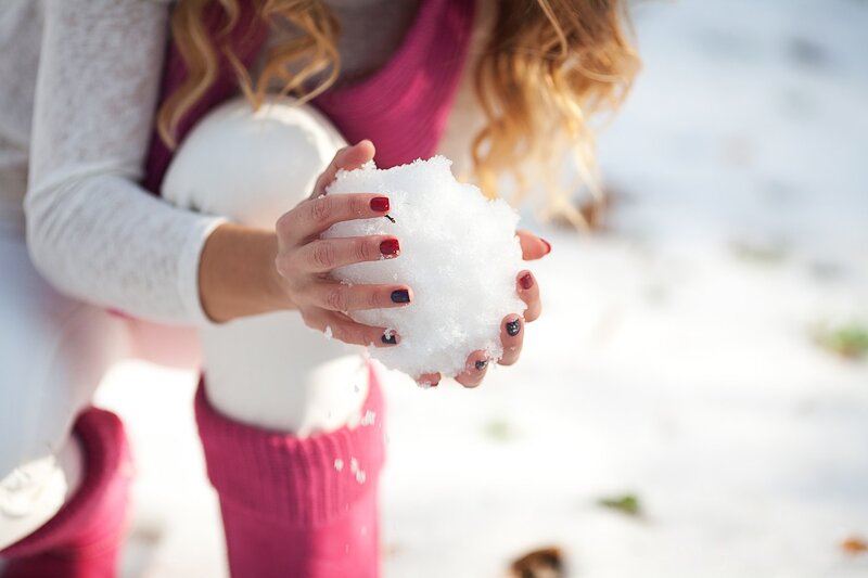 Woman Holding Snowball — White, Playful