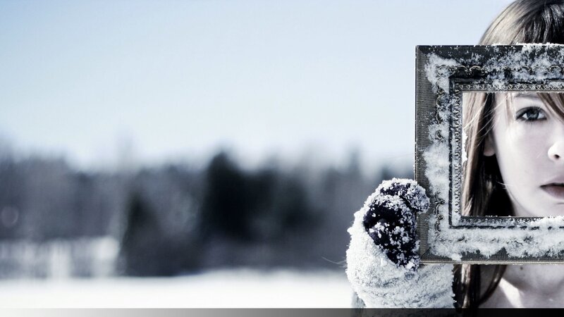 woman holding snowy frame