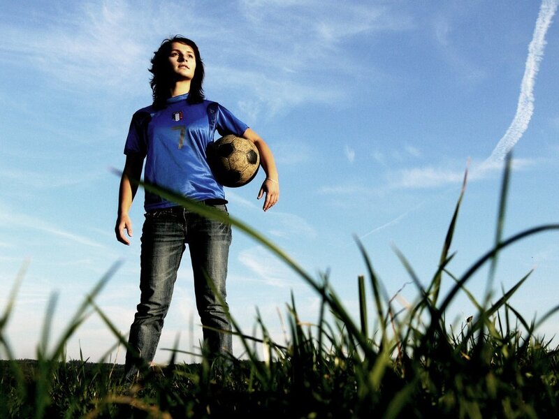 woman holding soccer ball