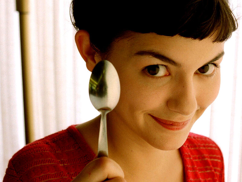 woman holding spoon near face