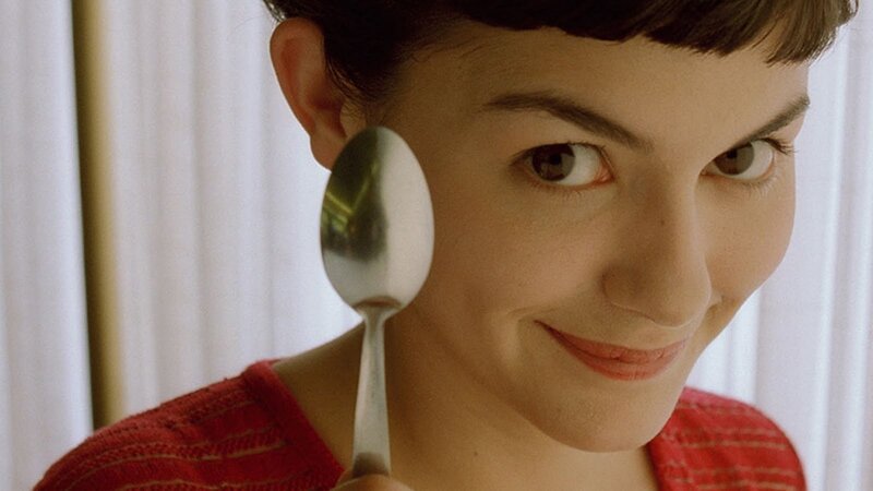 woman holding spoon near face